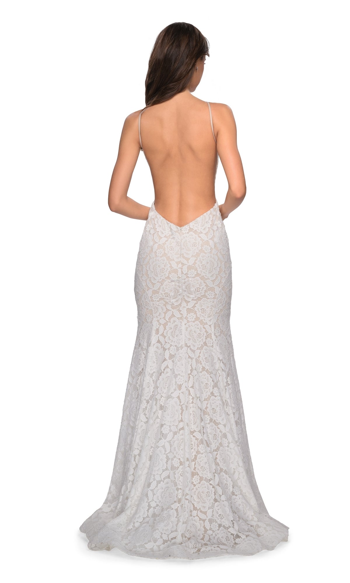 A woman stands facing away from the camera, wearing the La Femme Floral Lace Mermaid Prom Dress 27289 with thin straps and an open low V-back.